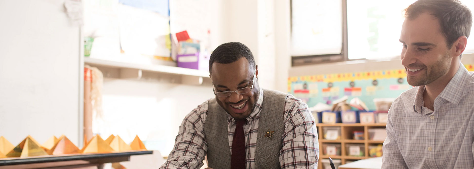 
		Two people working together and smiling		