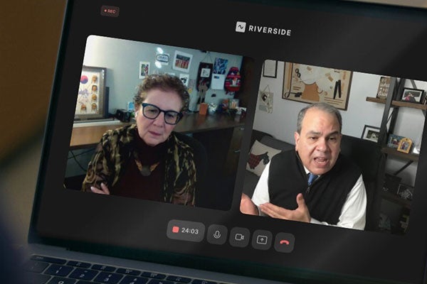 An image of a laptop screen with Dr. Joseph Sirven and Dean Carole Basile talking to each other via an video call.